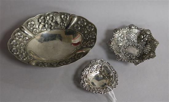 Two pierced silver bonbon dishes and a larger silver dish.